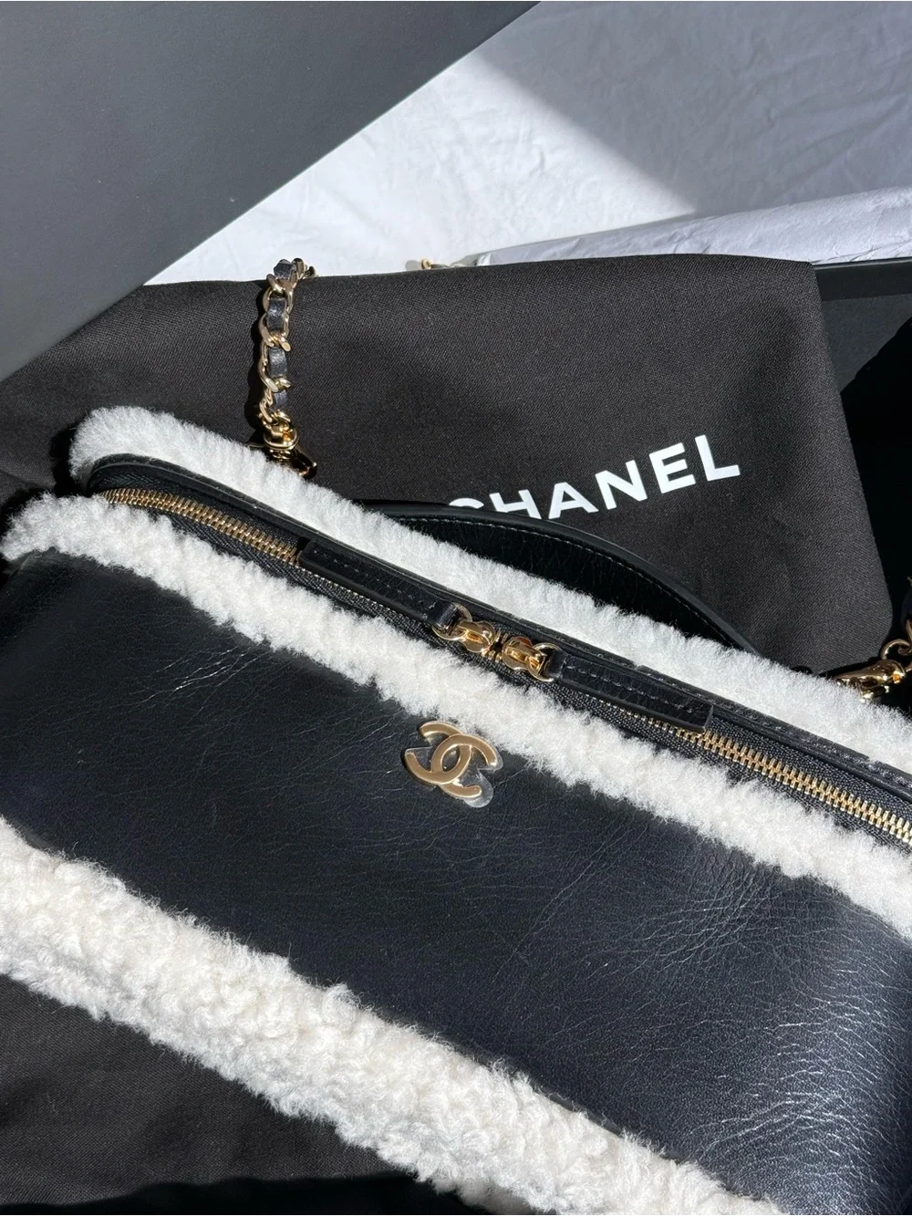 CHANEL Black Leather Shoulder Bag with White Shearling Trim